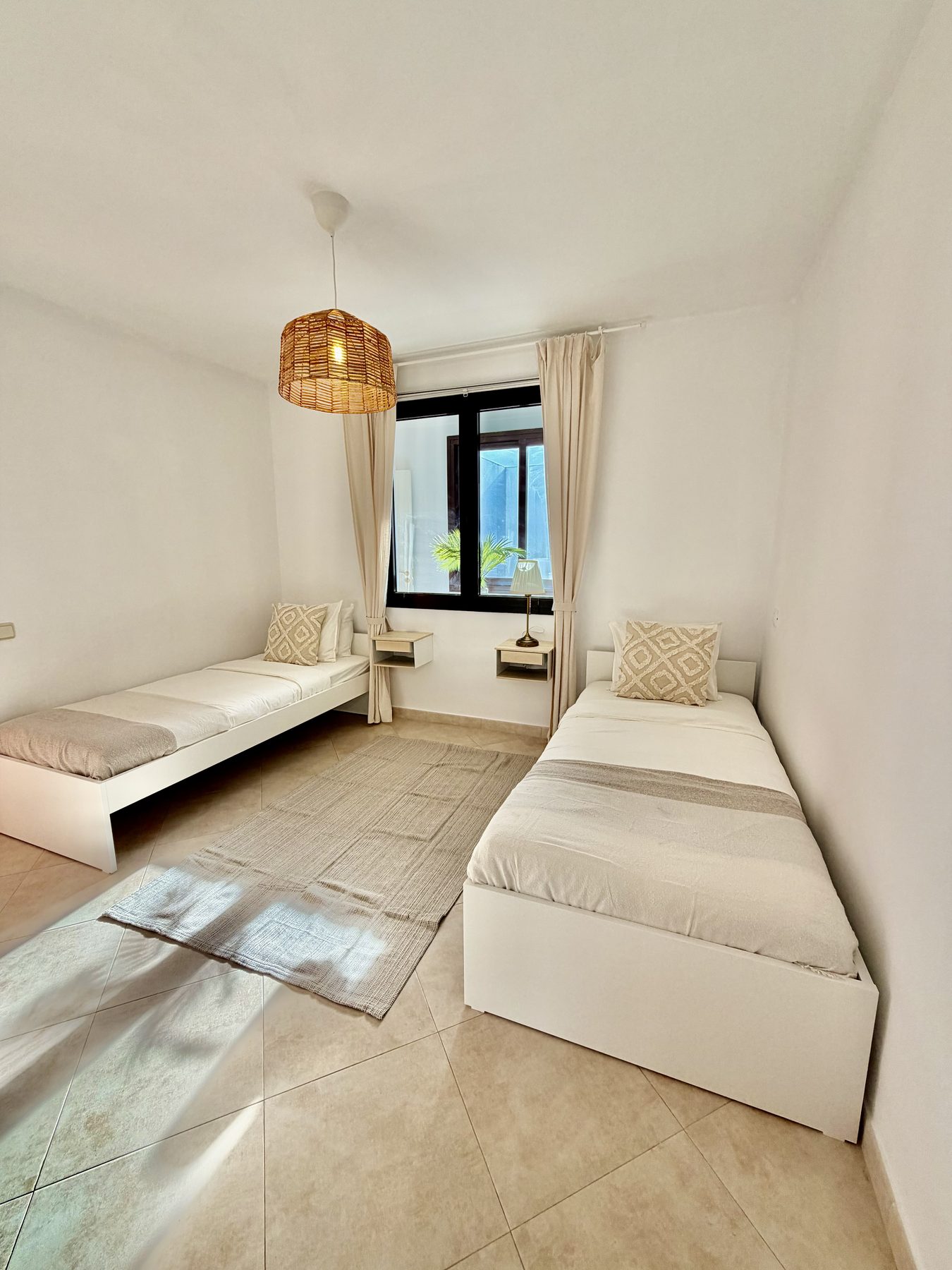 Second twin bedroom with sunlit window