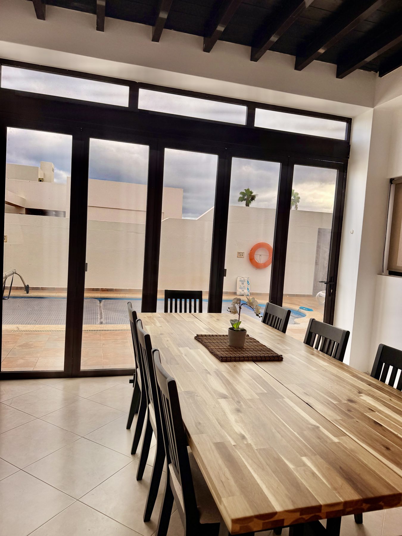 Dining room with large table opening to private pool