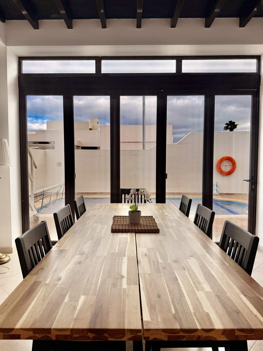 Indoor-outdoor dining with pool doors open